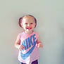 Oceanna is registered to the contest to win money with this photo: child, toddler, girl, smiling, pigtails, nike, pink, tshirt, shorts, heart_pattern, lollipop, white_sneakers, standing, indoor, floor, wall, happy, cute, person, casual_clothing