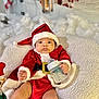 Amanda is registered to the contest to win money with this photo: baby, infant, christmas, santa_claus, holiday, bottle, milk, red_clothing, hat, blanket, plush, toy, cute, face, person, indoors, festive, child, smile, christmas_costume