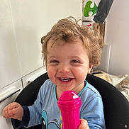 Lyzio participe au concours pour gagner de l'argent avec cette photo : baby, blue_shirt, casual_clothing, chair, child, curly_hair, cute, expression, face, furniture, hand, happy, indoor, person, pink_toy, playful, smiling, toddler, toy, young_child
