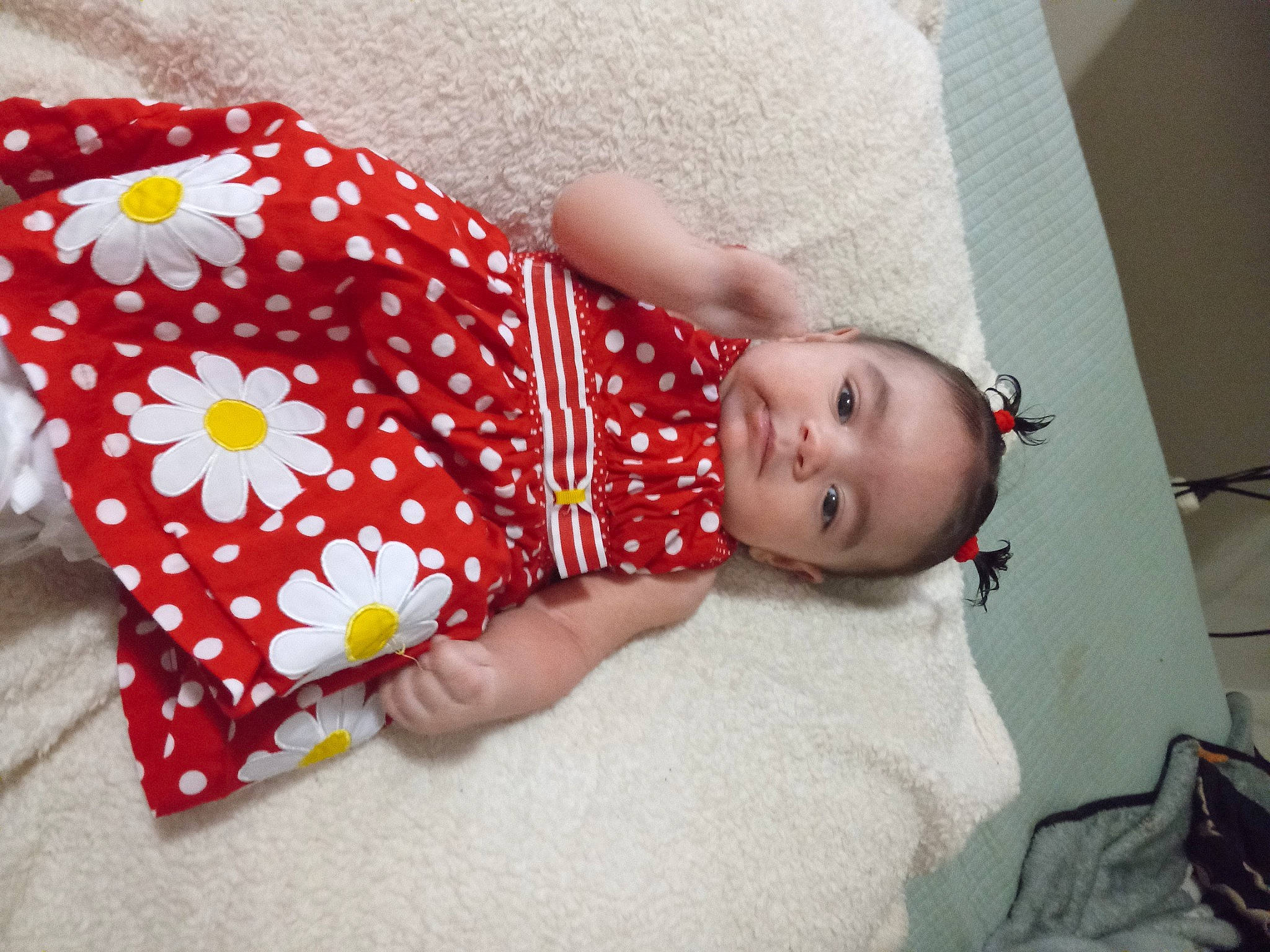 Rosa is registered to the contest to win money with this photo: baby, baby_products, baby_toddler_clothing, bed_sheet, bedding, child, comfort, day_dress, fashion_accessory, flooring, headgear, human_leg, linens, magenta, pattern, person, petal, room, sleeve, toddler