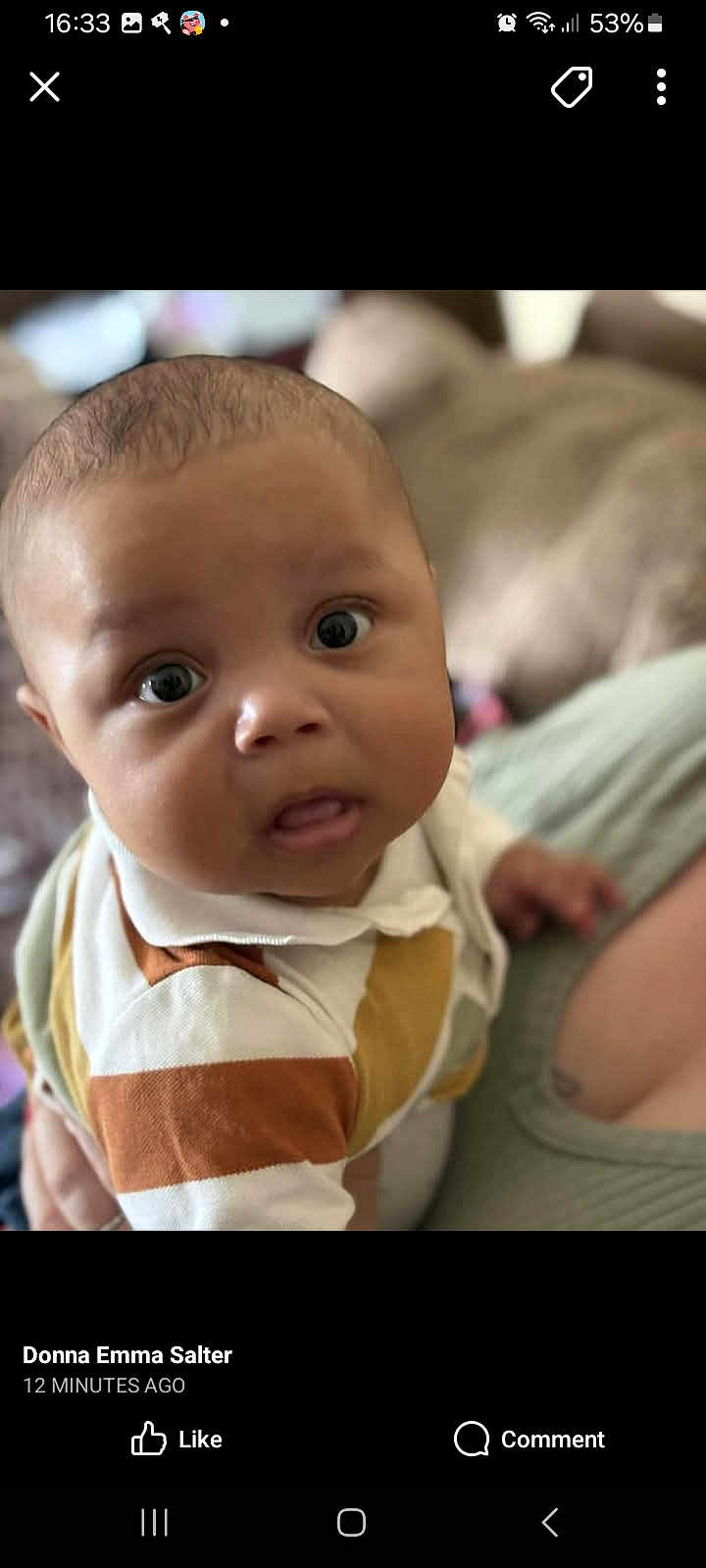 Oliver is registered to the contest to win money with this photo: baby, infant, face, eyes, expression, clothing, striped_shirt, skin, head, portrait, person, cute, child, closeup, indoors, human, young, curious, soft_background, warm_lighting