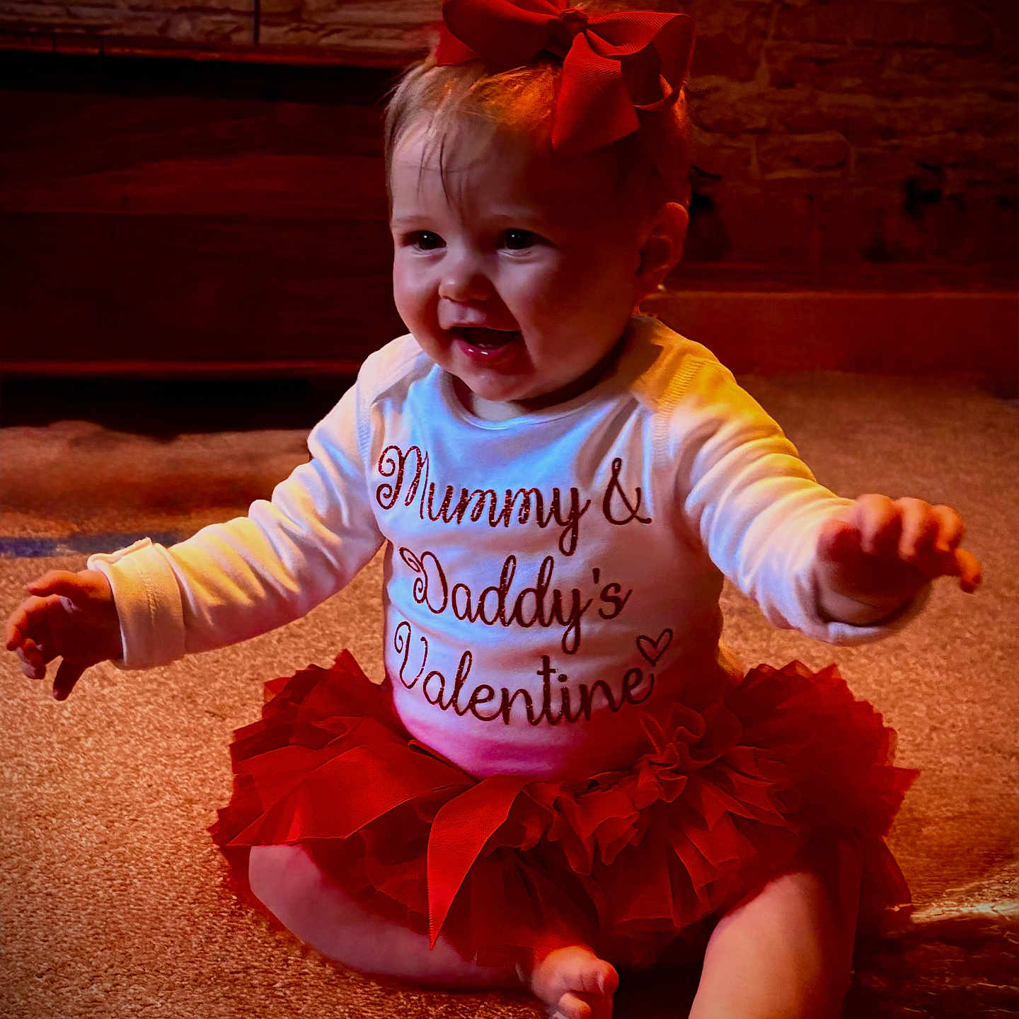 Elizabeth-Rose is registered to the contest to win money with this photo: accessories, baby, bodypart, clothing, costume, dancing, dress, face, finger, hand, hardwood, head, leisureactivities, person, photography, portrait, sitting, skirt, t_shirt, wood