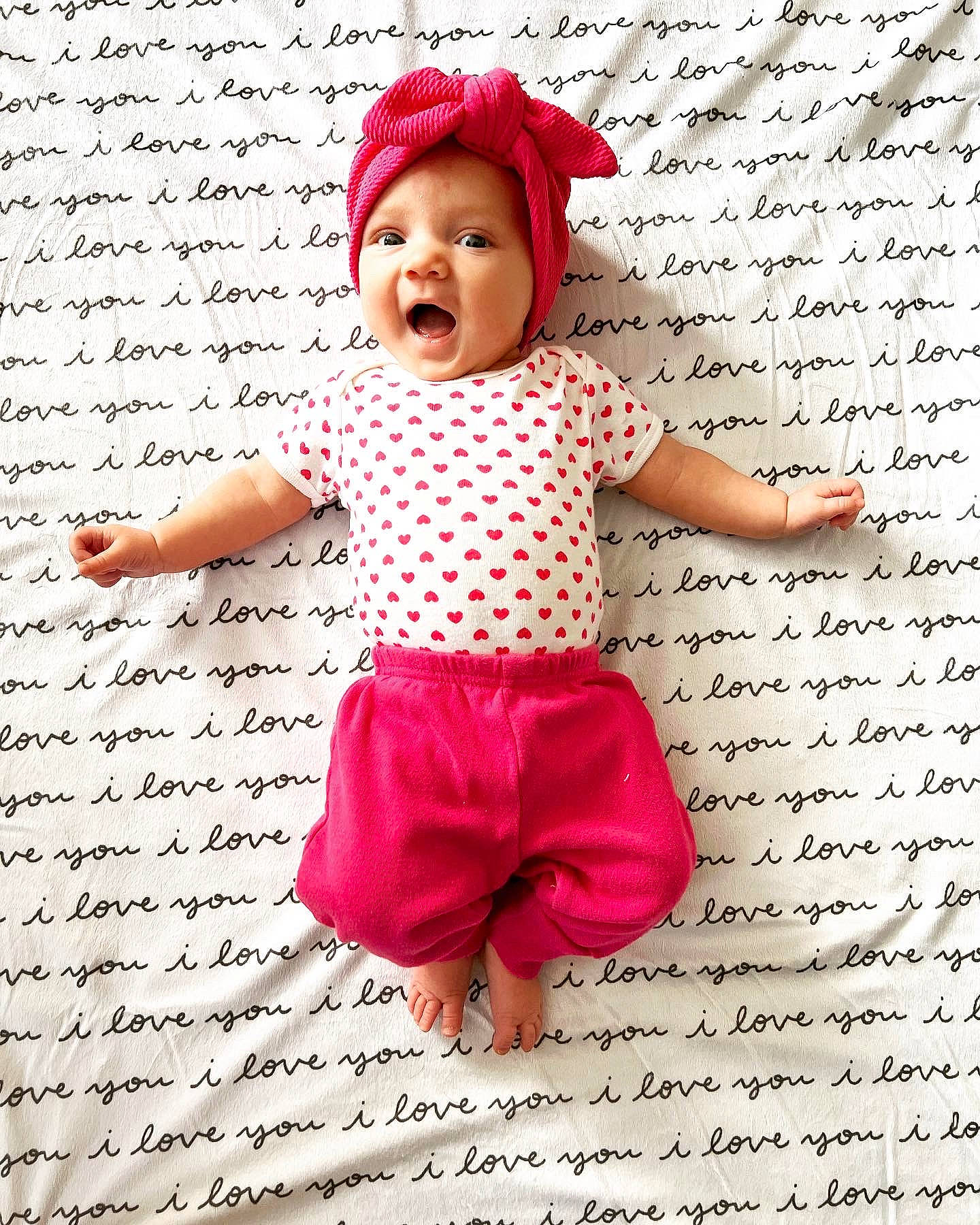 Payton is registered to the contest to win money with this photo: baby, baby_toddler_clothing, beauty, cap, child, facial_expression, fashion_accessory, font, gesture, handwriting, happy, headgear, magenta, pattern, person, pink, product, sleeve, smile, toddler