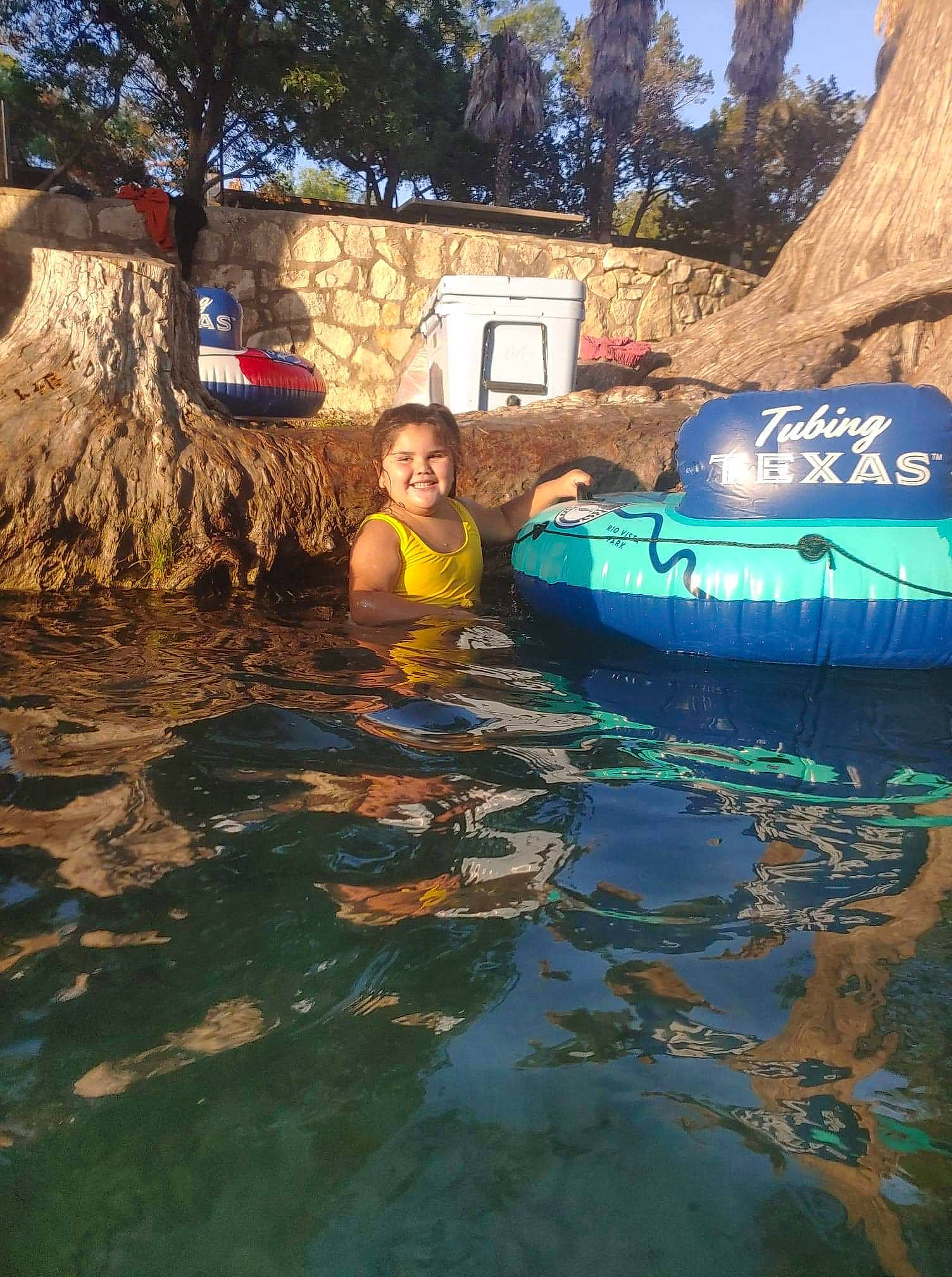 Leighla is registered to the contest to win money with this photo: bathing, boats_and_boating_equipment_and_supplies, body_of_water, event, fun, joy, lake, landscape, leisure, outdoor_recreation, person, personal_protective_equipment, recreation, reflection, rock, smile, swimming_pool, swimwear, travel, tree