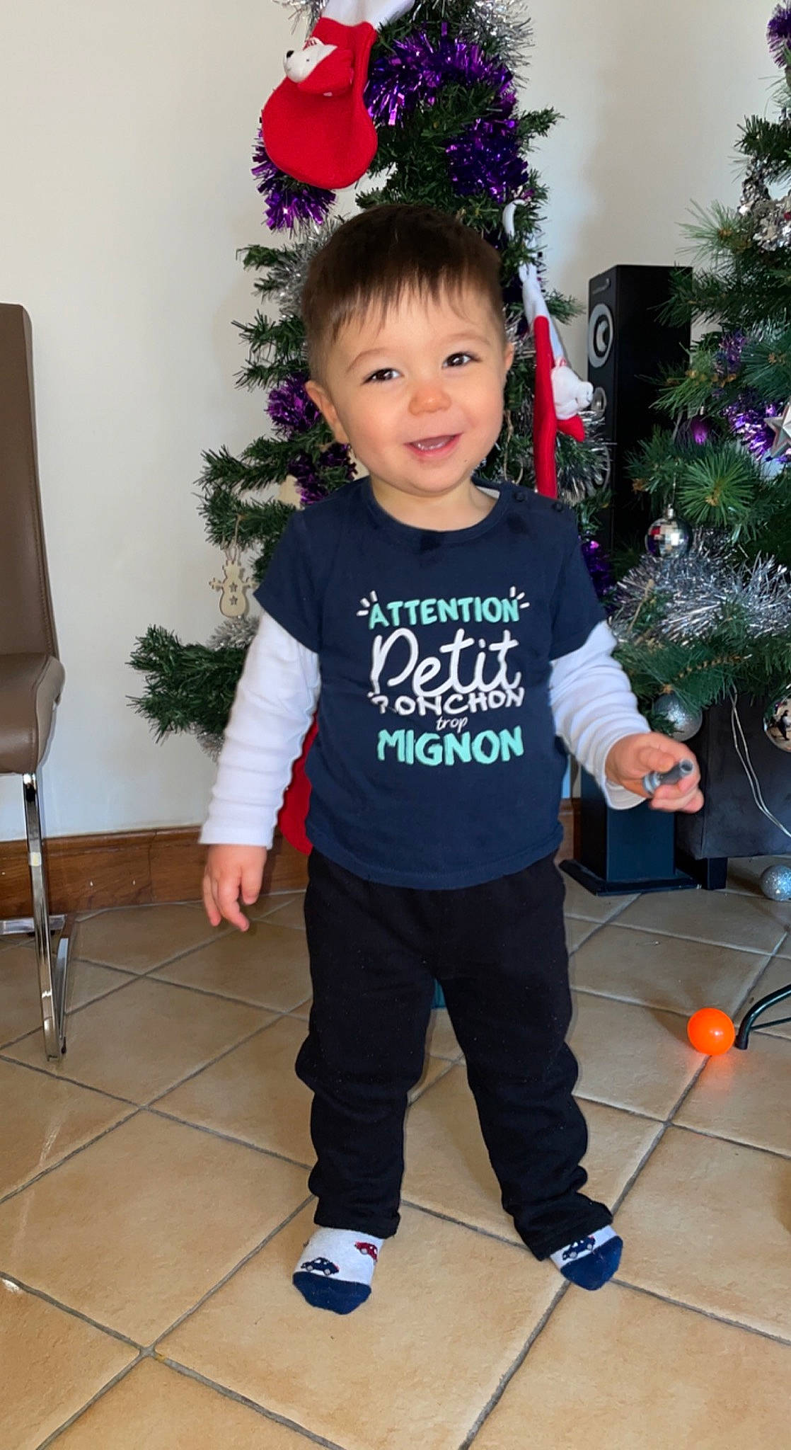 Rayane participe au concours pour gagner de l'argent avec cette photo : baby_toddler_clothing, child, christmas_decoration, christmas_ornament, cool, facial_expression, flooring, fun, hairstyle, happy, holiday_ornament, joy, leg, outerwear, person, sleeve, smile, snapshot, standing, sweatpant