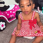 Sanai is registered to the contest to win money with this photo: toddler, child, girl, red_dress, curly_hair, hair_bows, carpet, toy_car, indoor, carpeted_floor, polka_dots, pink, white, red, cute, sitting, playroom, young_child, home