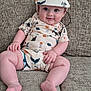 baby, infant, child, smiling, hat, couch, clothing, patterned_outfit, sitting, indoors, cute, chubby_cheeks, face, feet, hand, comfortable, expression, portrait, texture, happy