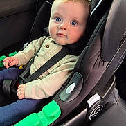 Arlo is registered to the contest to win money with this photo: baby, child, car_seat, blue_eyes, sweater, navy_pants, car_interior, seatbelt, strapped_in, infant, cute, portrait, child_safety, car_window, modern, black, green, comfort, curious, young