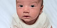 Keyhan joined the competition — help win amazing prizes! baby, infant, tummy, hands, fists, white_clothing, soft_skin, face, eyes, curious, lying_down, indoors, blanket, head, portrait, newborn, cute, child, person, closeup