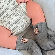 Keyhan joined the competition — help win amazing prizes! baby, legs, feet, socks, bear_face, hand, onesie, striped_clothing, blanket, soft_texture, infant, cute, cozy, resting, skin, child, toddler, closeup, comfort, warm