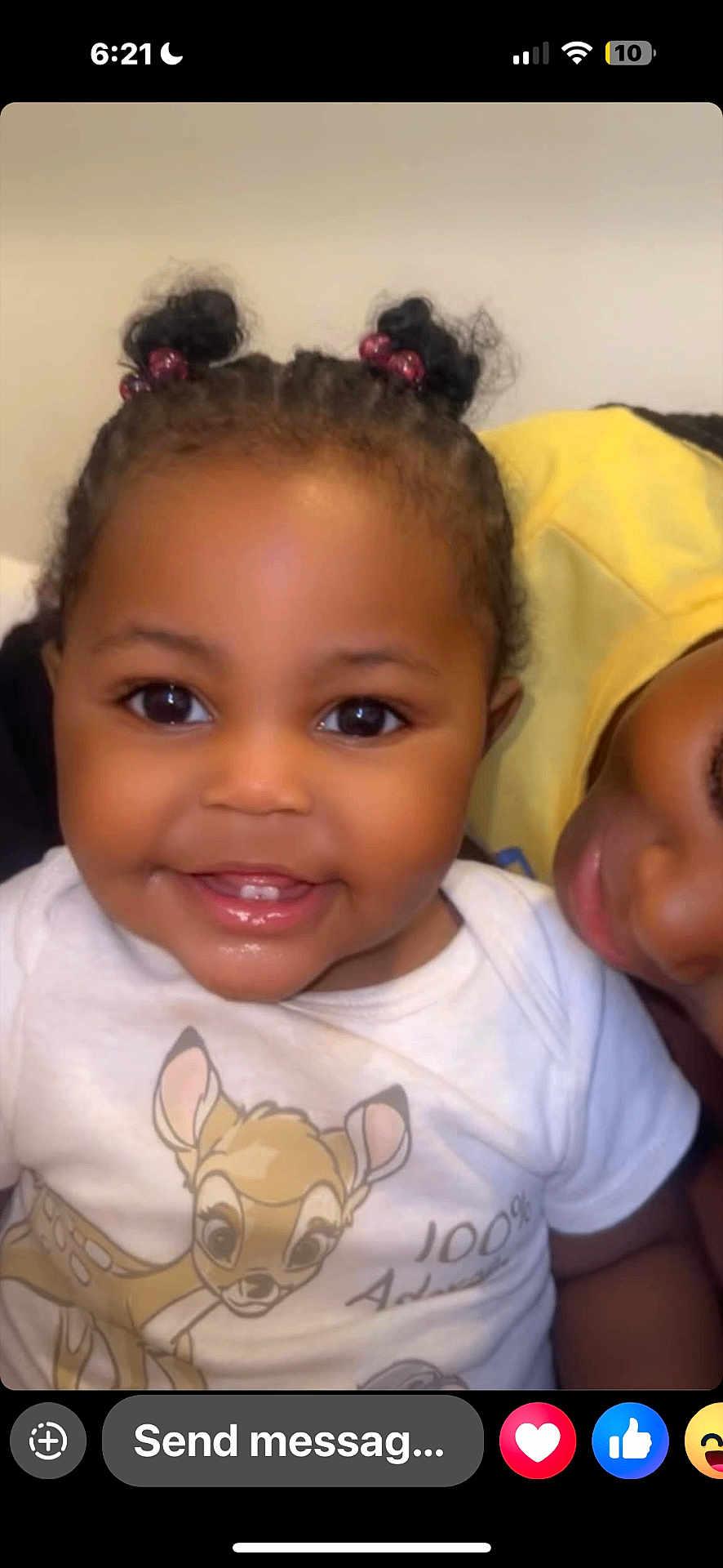 Kemora is registered to the contest to win money with this photo: baby, child, smiling, face, person, pigtails, shirt, cartoon, deer, cute, happy, closeup, indoor, family, love, black_hair, eyes, mouth, skin, infant