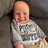 baby, child, smiling, couch, clothing, face, person, infant, cute, happy, indoors, sitting, shirt, fabric, home, portrait, relaxing, cozy, skin, young