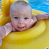 baby, infant, pool, water, yellow_inflatable, float, child, happy, smiling, summer, outdoor, blue_water, skin, face, cute, reaching, playful, floating, sunlight, vacation