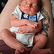 Cypress joined the competition — help win amazing prizes! adult_lap, baby, bare_feet, bib, close_up, cradled, family, folded_arms, indoors, infant, newborn, peaceful, photography, portrait, sitting, sleeping, soft_lighting, sports_logo, tattoo, white_onesie
