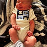 Cypress is registered to the contest to win money with this photo: baby, blanket, clothing, cozy, face, family_photo, foot, furniture, indoors, infant, newborn, north_carolina, onesie, portrait, relaxed, seated, sleeping, sock, sports_fan, team_logo