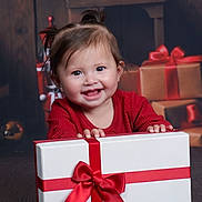 Anniliah joined the competition — help win amazing prizes! baby, child, smiling, gift, present, red_ribbon, holiday, christmas, pigtails, happy, portrait, indoors, festive, wrapped_presents, cute, young_child, clothing, holiday_decor, celebration, joyful