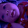 Adrin is registered to the contest to win money with this photo: baby, infant, face, closeup, purple_light, hat, red_clothing, pacifier, lying_down, sleepwear, child, cute, portrait, indoors, soft_light, star_pattern, young, expression, headwear, resting