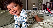 Krishiv joined the competition — help win amazing prizes! bed, blanket, child, cozy, crawling, curly_hair, cute, face, furniture, happy, home, indoor, lamp, person, pillow, playful, smiling, sweater, toddler, young_child