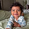 Krishiv is registered to the contest to win money with this photo: toddler, child, smiling, curly_hair, bed, pillow, blanket, indoor, happy, cute, person, home, cozy, face, infant, clothing, resting, portrait, young_child, relaxed