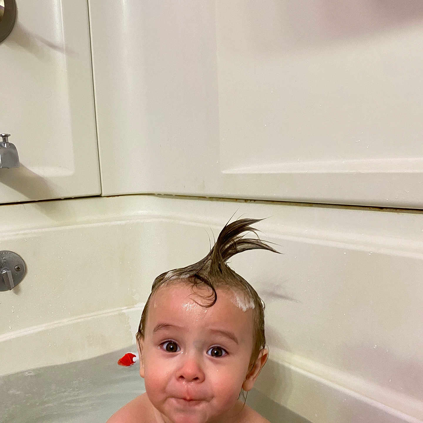Dakotah is registered to the contest to win money with this photo: baby, bathing, bathroom, bathtub, bodypart, face, finger, hair, hand, happy, head, indoors, person, photography, portrait, room, shower, smile, spitting, tub