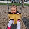 toddler, child, swing, playground, yellow_swing, pink_booties, white_tights, black_jacket, hair_tie, outdoor, wood_chips, tree, park, fun, happy, play, person, daytime, clothing, seat