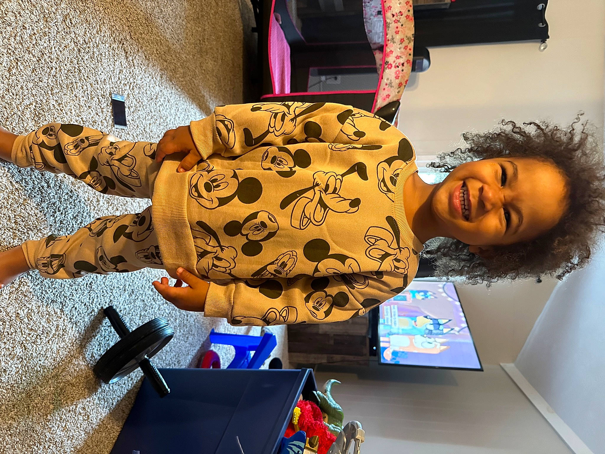 Levi is registered to the contest to win money with this photo: backpack, bag, child, comfort, eyewear, fashion_design, flooring, fun, joy, leisure, luggage_and_bags, office_equipment, pattern, person, room, sitting, smile, travel, visual_arts