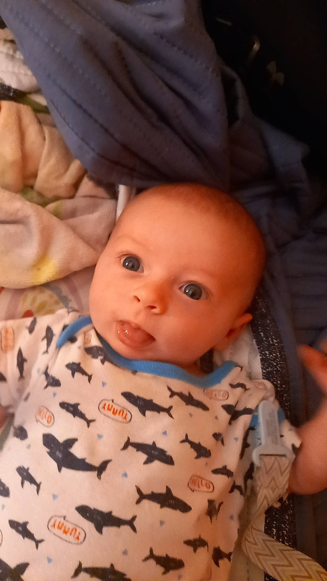 Jaxon is registered to the contest to win money with this photo: baby, baby_toddler_clothing, cap, cheek, child, comfort, eye, eyebrow, eyelash, forehead, head, iris, lip, mouth, nose, pattern, person, sitting, skin, sleeve