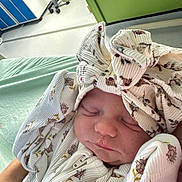 Esmerelda-Rose joined the competition — help win amazing prizes! newborn, baby, sleeping, onesie, headband, floral_pattern, hospital, bed, blanket, closeup, infant, person, soft_light, peaceful, cozy, cute, clothing, hands, face, portrait