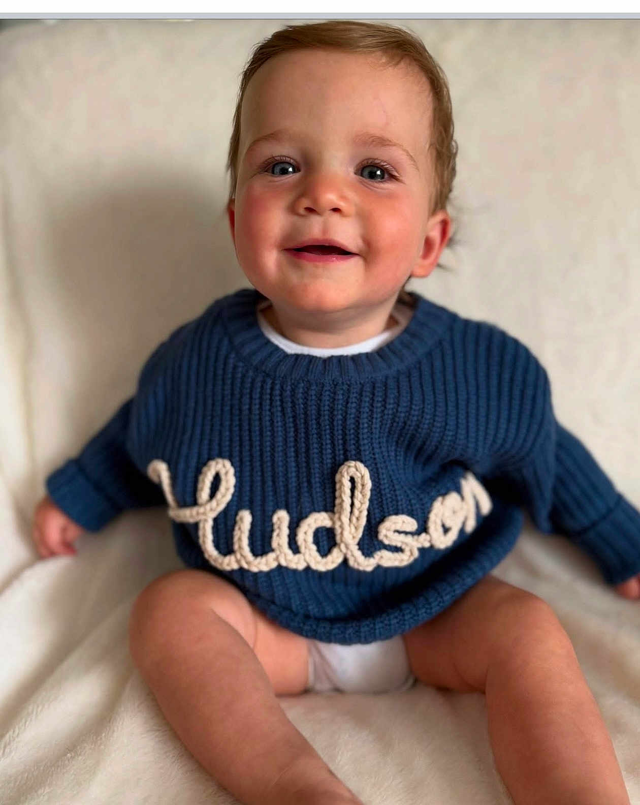 Hudson joined the competition — help win amazing prizes! baby, child, smiling, blue_sweater, knitted, name, hudson, sitting, blanket, soft, cute, portrait, happy, infant, indoors, clothing, warm, skin, face, eyes