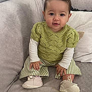 Ayna participe au concours pour gagner de l'argent avec cette photo : baby, child, comfortable, couch, cozy, cute, gray_couch, green_sweater, hands, indoors, knitwear, pigtails, pillow, portrait, sitting, smiling, soft_shoes, striped_pants, toddler, young_child