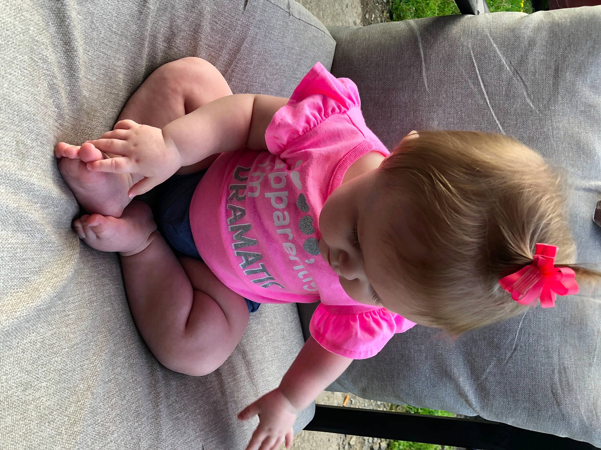 Adyson is registered to the contest to win money with this photo: baby, baby_toddler_clothing, cheek, comfort, eye, face, finger, glasses, grass, hand, head, human_body, joint, leaf, leg, person, pink, plant, skin, thigh