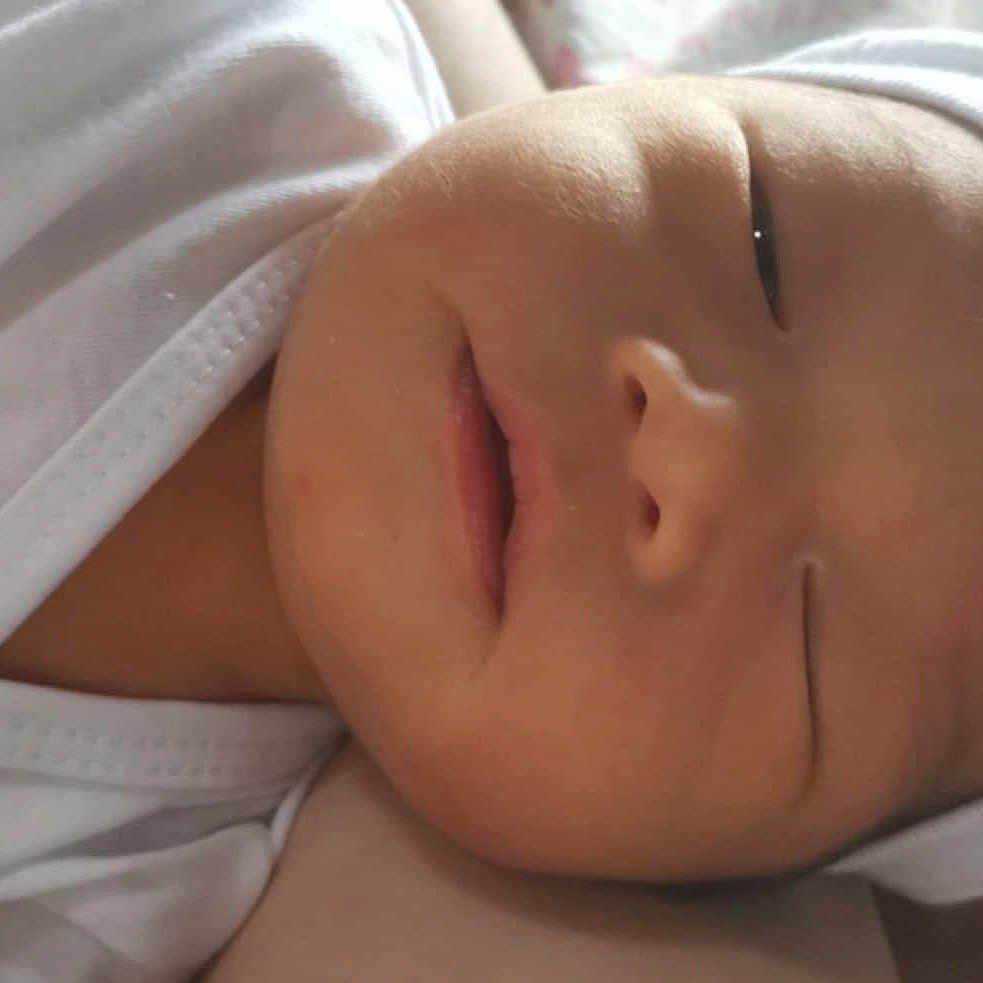 Kyler Lorenzo joined the competition — help win amazing prizes! baby, bed, blanket, cap, child, closeup, cute, face, headwear, indoors, infant, newborn, peaceful, portrait, resting, skin, sleeping, soft_light, white_clothing, young