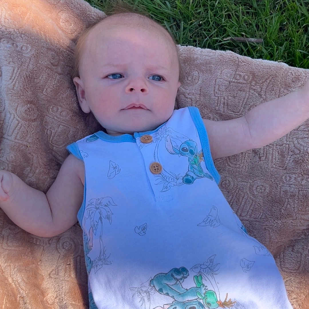 Lennox is registered to the contest to win money with this photo: baby, blanket, chair, clothing, couch, cushion, dress, face, furniture, grass, head, homedecor, lawn, linen, newborn, person, photography, plant, portrait, t_shirt