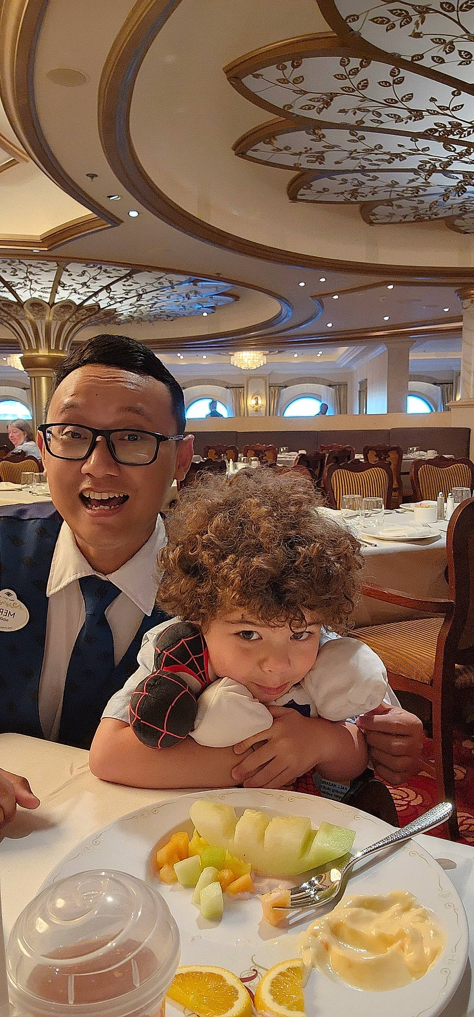 Greyson joined the competition — help win amazing prizes! chair, comfort_food, conversation, event, finger_food, food, formal_wear, fun, glasses, happy, joy, junk_food, meal, person, plate, room, suit, table, tableware, tie