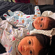 Azriel And Atlas joined the competition — help win amazing prizes! baby, infant, pajamas, blanket, bed, face, child, cute, indoor, sleepwear, two_children, lying_down, soft_lighting, curious, young_child, head, person, cozy, closeup, expression