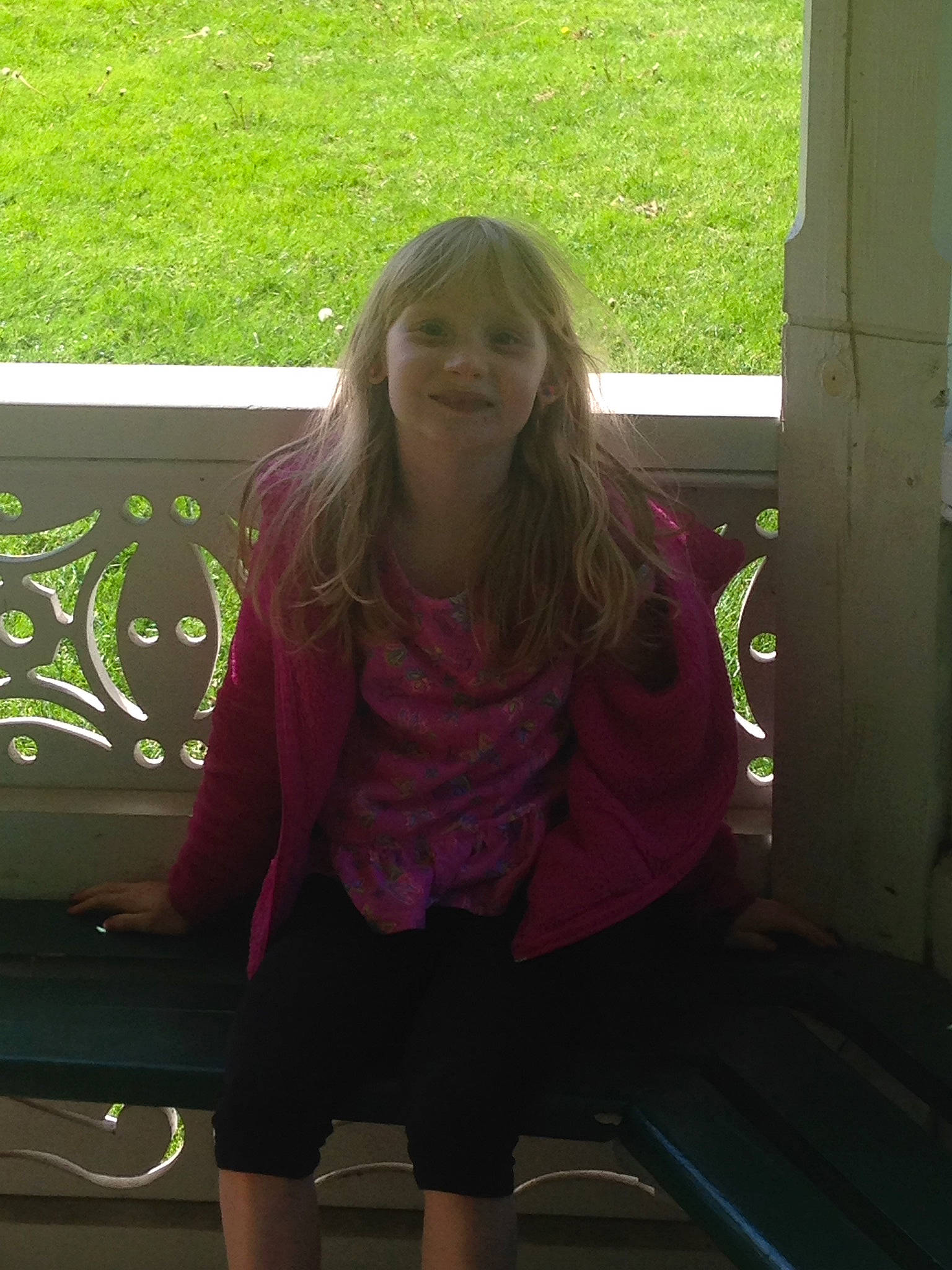 Cheyanne is registered to the contest to win money with this photo: blond, child, cool, electric_blue, facial_expression, fun, grass, happy, joy, leisure, long_hair, magenta, pattern, person, shorts, sitting, sleeve, smile, standing, t_shirt