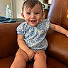 Isabella joined the competition — help win amazing prizes! baby, child, smiling, blue_outfit, floral_pattern, sitting, couch, leather, indoors, bottle, window, home, furniture, happy, cute, person, infant, portrait, skin, short_hair