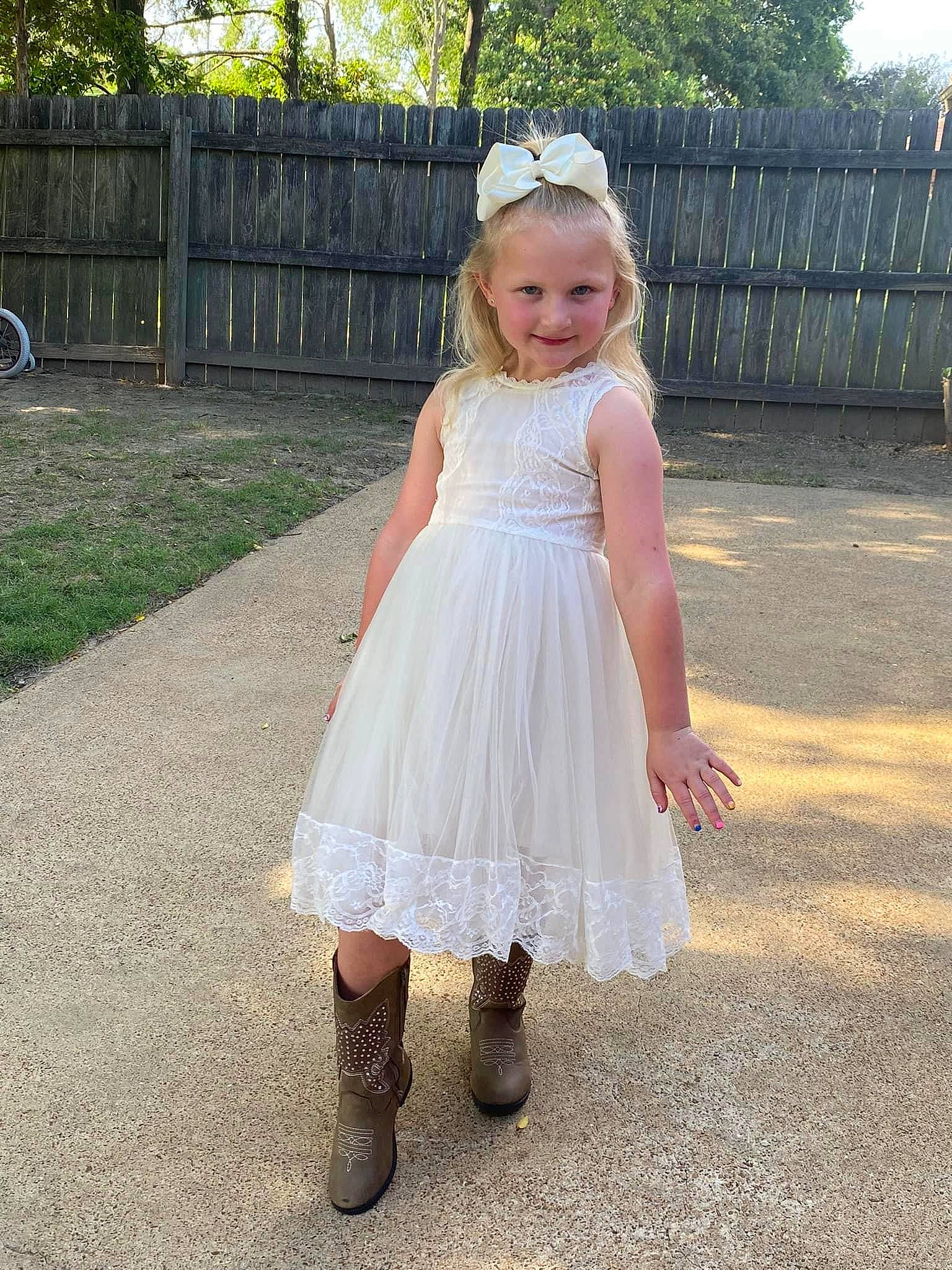 Lakelyn is registered to the contest to win money with this photo: baby_toddler_clothing, bridal_accessory, bridal_party_dress, day_dress, dress, footwear, formal_wear, fun, grass, happy, headgear, joy, knee, one_piece_garment, pattern, person, plant, recreation, shoulder, toddler