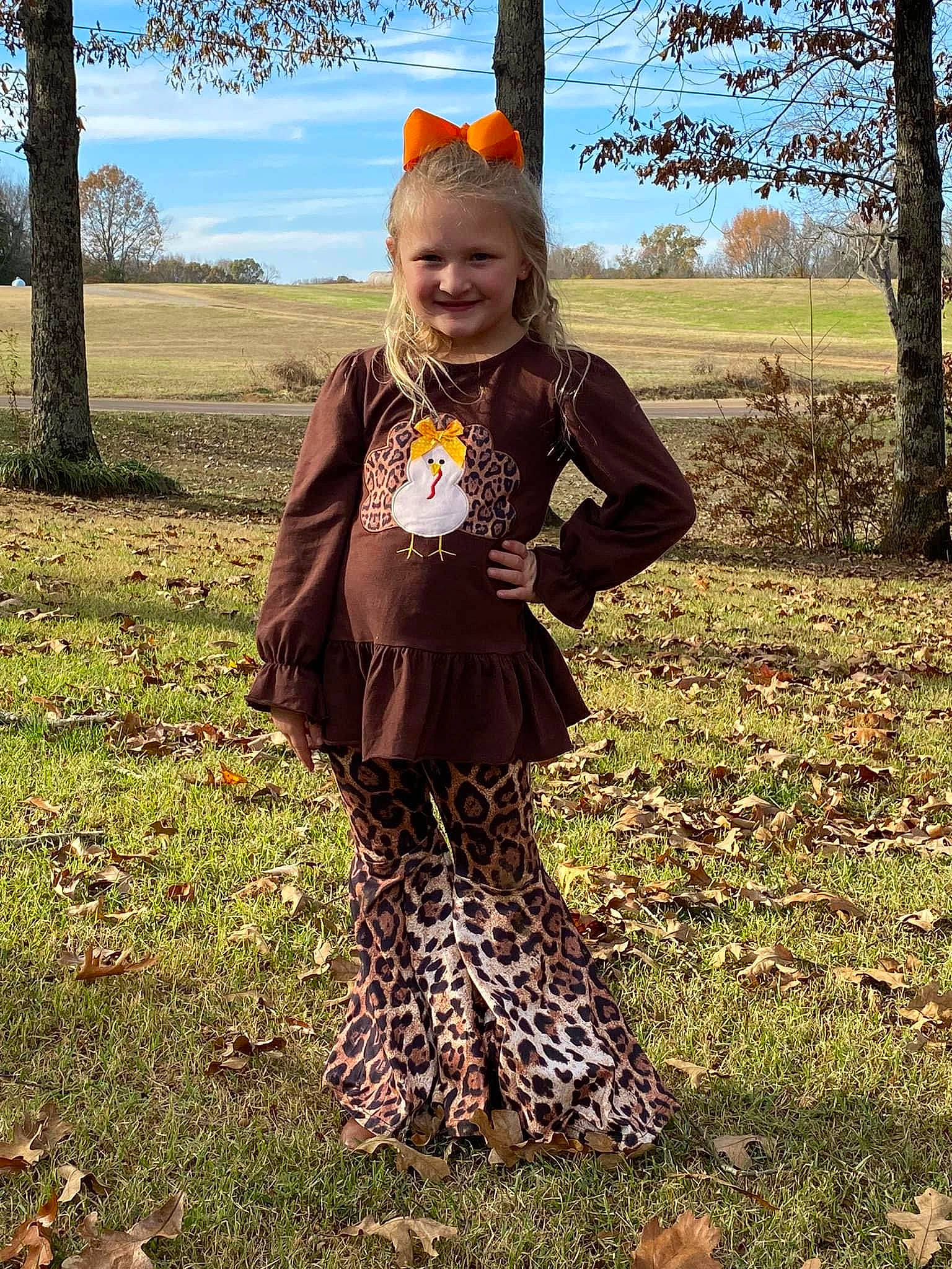 Lakelyn joined the competition — help win amazing prizes! baby_toddler_clothing, blond, brown_hair, child, grass, grassland, happy, joy, leaf, outerwear, pattern, people_in_nature, person, plant, prairie, pumpkin, sky, sleeve, smile, spring