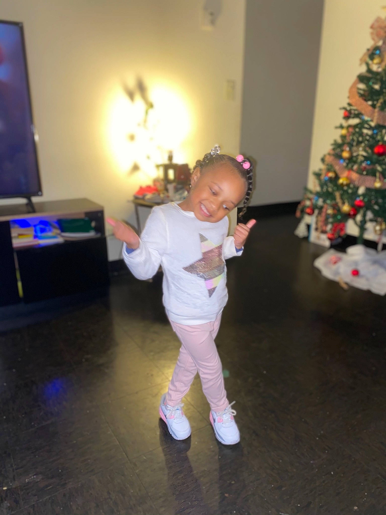 Amiyah joined the competition — help win amazing prizes! baby_toddler_clothing, blurred, child, christmas, christmas_decoration, christmas_eve, christmas_ornament, christmas_tree, conifer, event, flooring, fun, happy, holiday, holiday_ornament, joy, person, smile, sock, standing