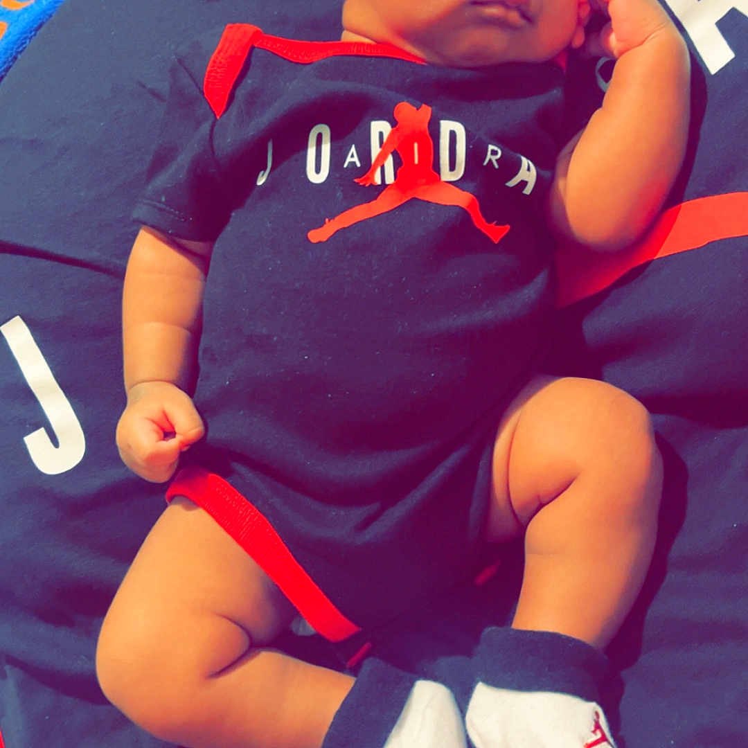 Frederick is registered to the contest to win money with this photo: baby, baseballcap, bodypart, cap, clothing, cushion, face, finger, glove, hand, hat, head, homedecor, newborn, person, photography, portrait, shorts, sleeping, t_shirt