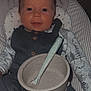 baby, bed, bowl, clothing, couch, cup, cutlery, dish, face, food, fork, furniture, head, homedecor, meal, pants, person, photography, portrait, spoon