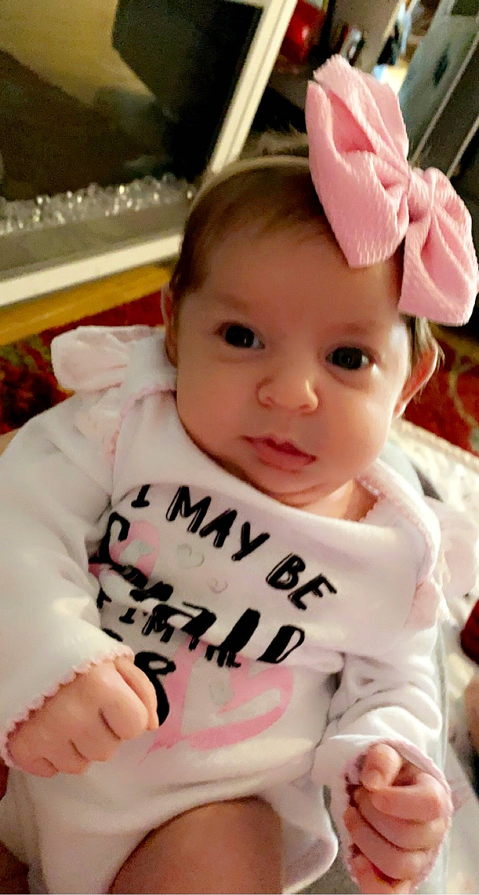 Sophia joined the competition — help win amazing prizes! baby, baby_products, baby_toddler_clothing, cap, cheek, child, chin, eyebrow, eyelash, face, fun, gesture, happy, lip, person, petal, pink, sitting, skin, thumb