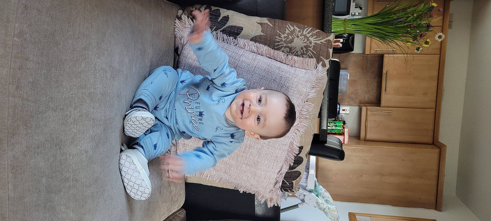 Jake is registered to the contest to win money with this photo: baby, baby_carriage, baby_products, baby_toddler_clothing, child, comfort, couch, houseplant, joy, lamp, linens, living_room, nap, person, picture_frame, pillow, plant, room, sitting, smile