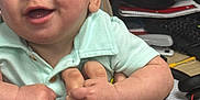 Jesse is registered to the contest to win money with this photo: baby, child, clothing, cute, desk, fingers, hand, happy, holding, indoor, keyboard, office, paper, person, portrait, sitting, skin, smiling, table, tattoo