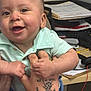 baby, child, clothing, cute, desk, fingers, hand, happy, holding, indoor, keyboard, office, paper, person, portrait, sitting, skin, smiling, table, tattoo