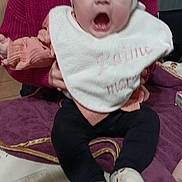 Aïnhoa participe au concours pour gagner de l'argent avec cette photo : baby, bib, blanket, child, clothing, cute, expression, floor, happy, headband, holding, indoor, person, pink, purple, smiling, socks, sweater, table, warm