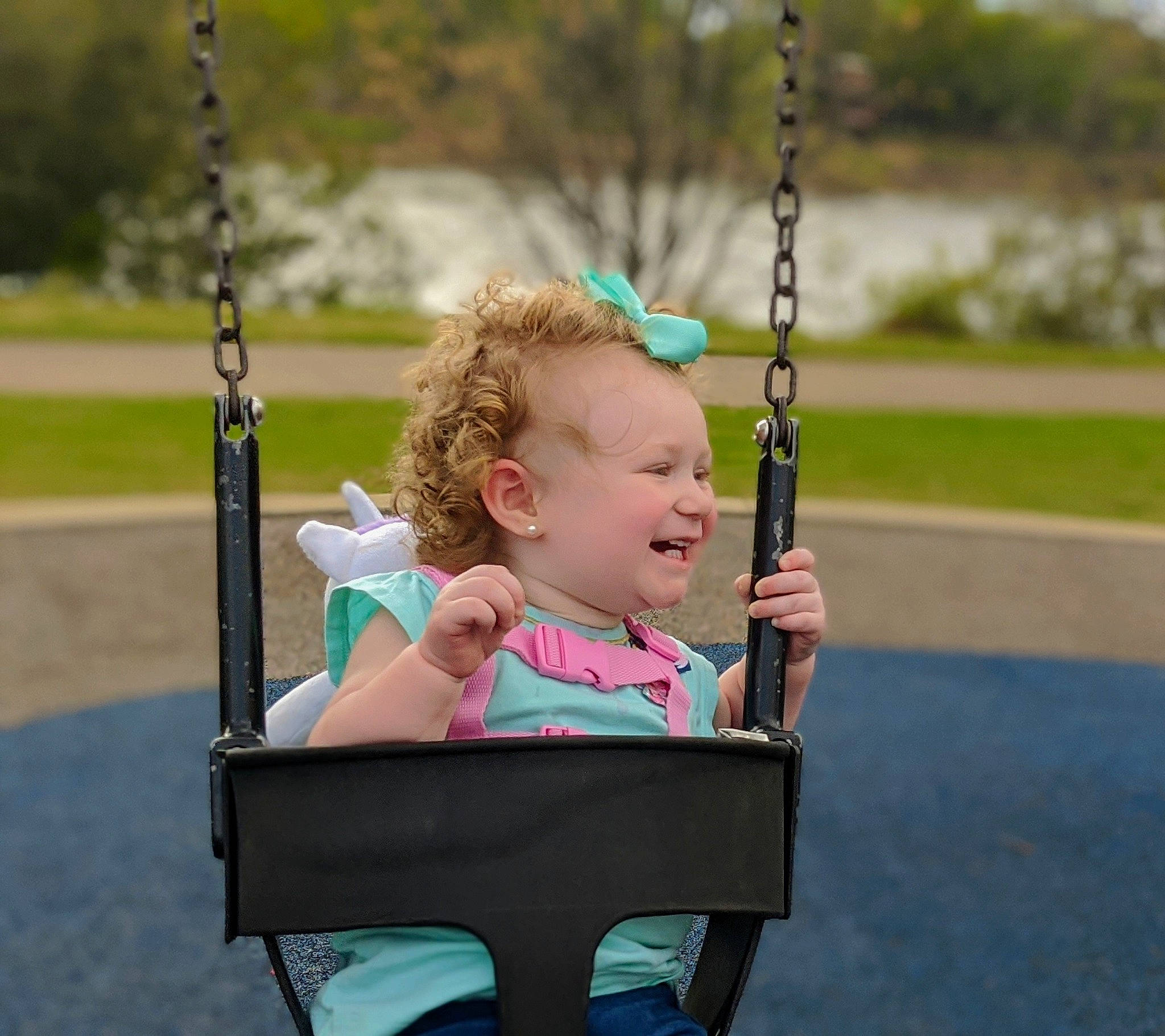 Braylynn is registered to the contest to win money with this photo: child, fun, leisure, outdoor_play_equipment, person, play, playground, public_space, recreation, smile, swing, toddler, tree