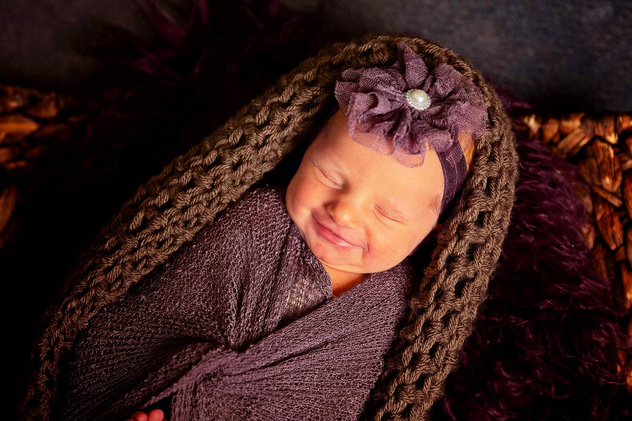 Lilith is registered to the contest to win money with this photo: baby, cap, chin, eye, eyebrow, flash_photography, fur, grass, happy, head, headgear, knit_cap, lip, neck, person, shawl, skin, toddler, wood, wool