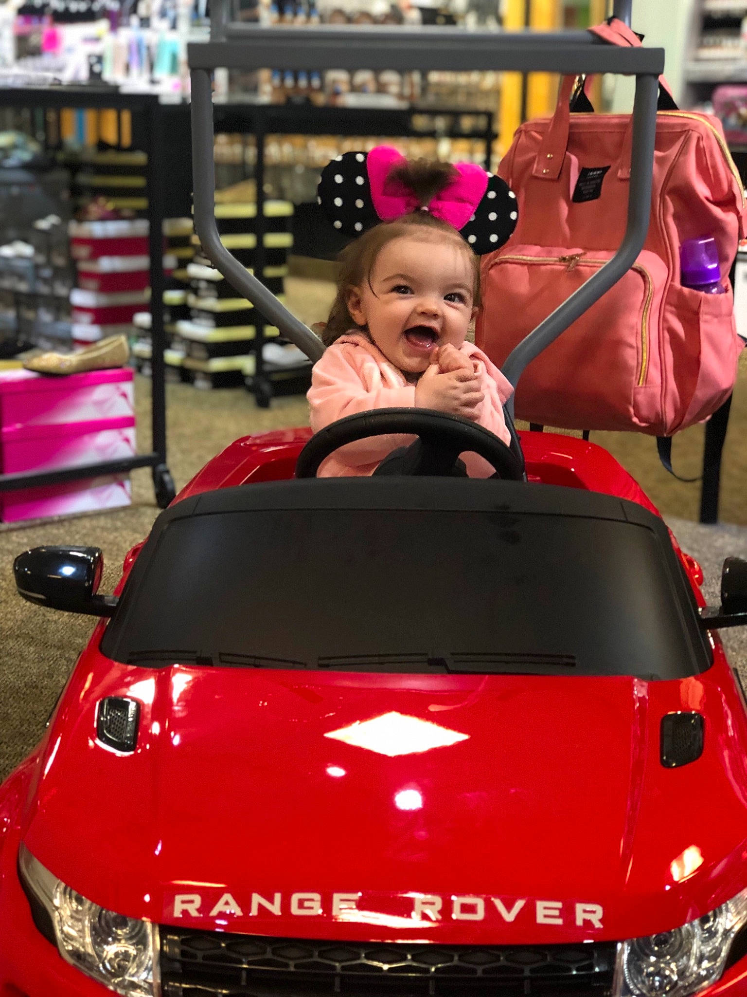 Braelynn is registered to the contest to win money with this photo: auto_part, automotive_design, automotive_exterior, car, city_car, compact_car, family_car, hood, motor_vehicle, performance_car, person, pink, red, sport_utility_vehicle, subcompact_car, vehicle